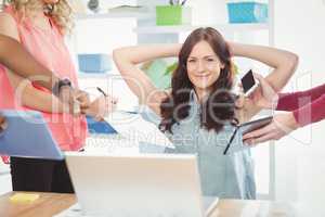 Portrait of smiling woman with hands behind head