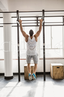 Rear view of man doing pull ups