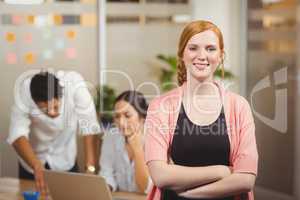 Portrait of businesswoman standing with arms crossed in office