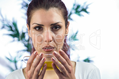 Confident woman holding herbal tea