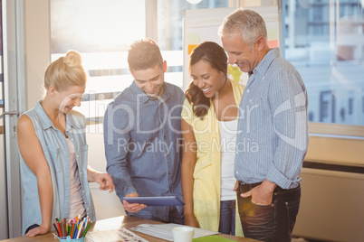 Business people looking at digital tablet in meeting room