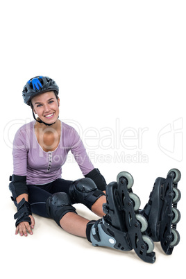 Portrait of happy female inline skater resting