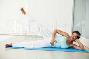 Happy pregnant woman exercising at home
