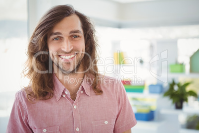 Portrait of happy hipster in office