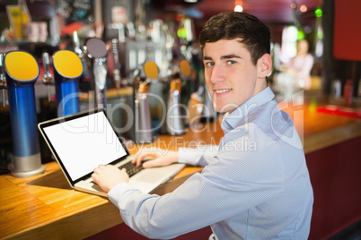 Portrait of happy man using laptop