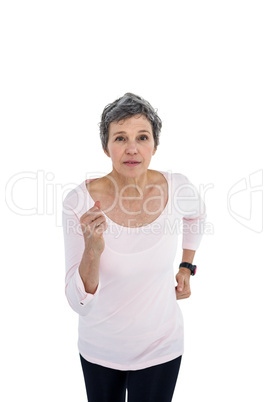 Mature woman jogging against white background