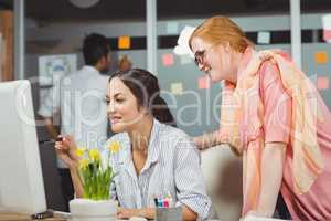 Smiling businesswomen using computer in office