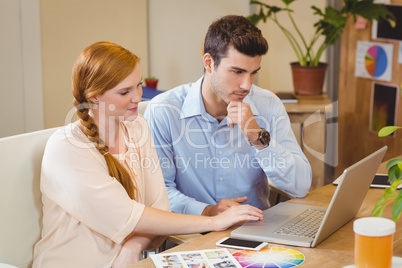 Business people using digital tablet at desk