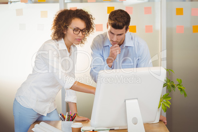 Business people standing by table