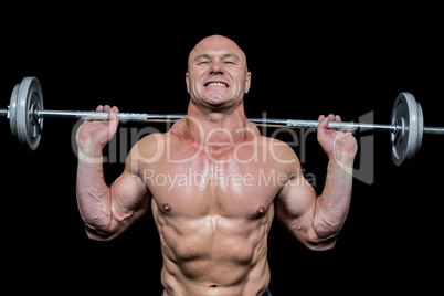 Confident muscular man lifting crossfit