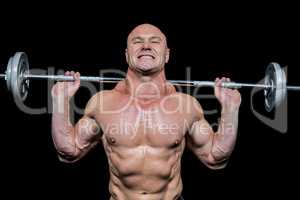 Confident muscular man lifting crossfit