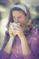 Happy woman sipping coffee
