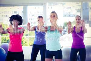 Focused women with arms stretched forward