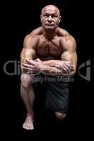 Muscular man kneeling down