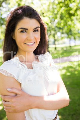 Portrait of cheerful confident woman in park