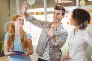 Businessman gesturing while female colleagues looking at him