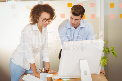 Business people standing by table