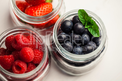 Glass jars of fresh berries