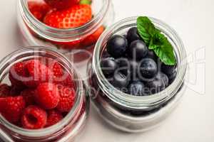 Glass jars of fresh berries