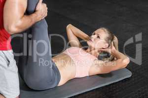 Trainer helping her client stretch legs