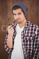 Portrait of  confident hipster holding smoking pipe