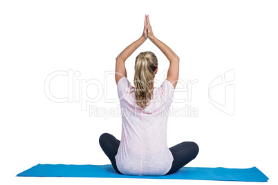 Rear view of fit woman in yoga position