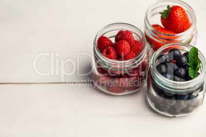 Glass jars of fresh berries