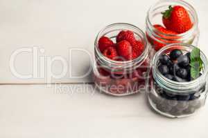 Glass jars of fresh berries