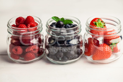 Glass jars of fresh berries