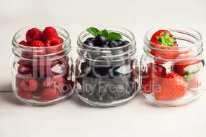 Glass jars of fresh berries