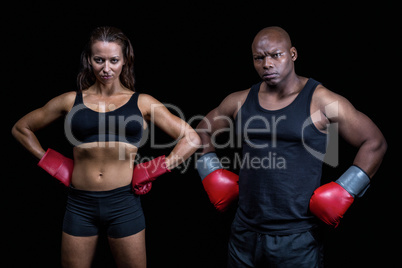 Portrait of male and female boxers with hands on hip