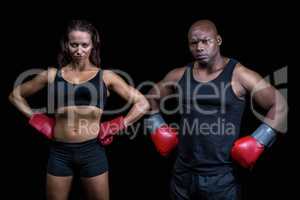 Portrait of male and female boxers with hands on hip