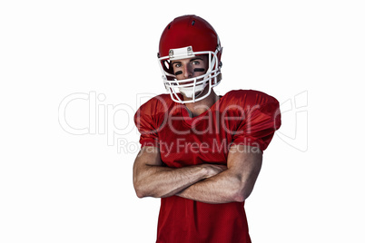 Portrait of rugby player wearing helmet with arms crossed