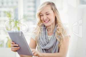 Happy woman holding digital tablet