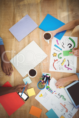 Directly above shot of cropped hands working at desk