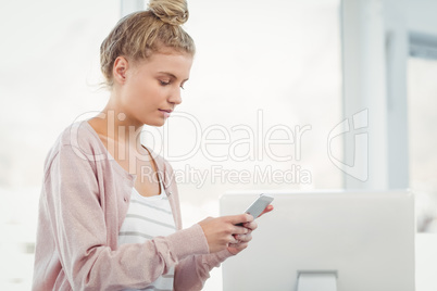 Woman using smartphone in office