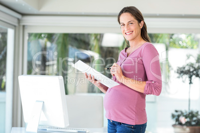 Portrait of pregnant woman with file