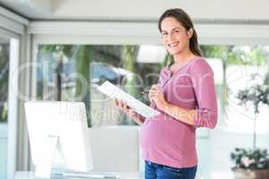 Portrait of pregnant woman with file