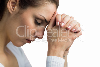 Peaceful woman praying with joining hands and eyes closed