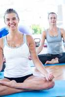 Cropped image of woman smiling while doing lotus pose