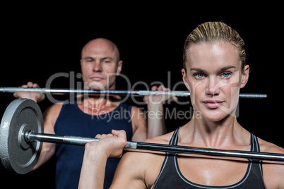 Portrait of woman and man lifting crossfit