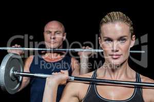 Portrait of woman and man lifting crossfit