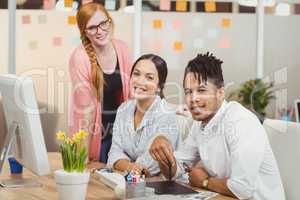 Portrait of smiling businessman with female colleagues