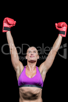 Winner female boxer with arms raised