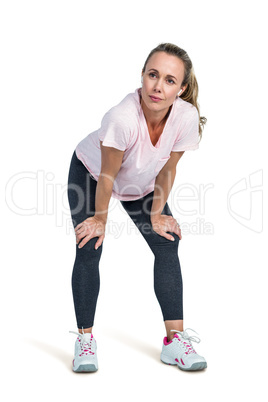 Thoughtful sporty woman bending