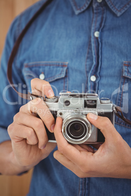 Man adjusting camera lens