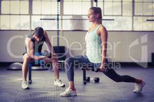 Serious couple exercising with dumbbells