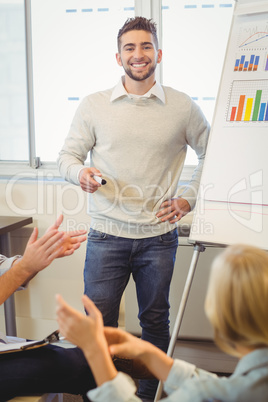 Portrait of handsome businessman giving presentation