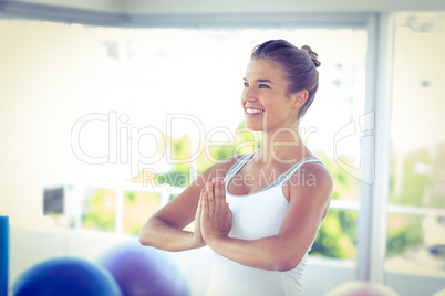 Beautiful woman smiling with hands joined