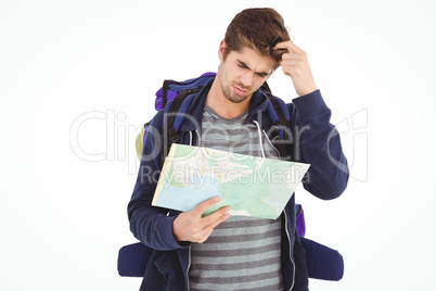 Man scratching head looking in map